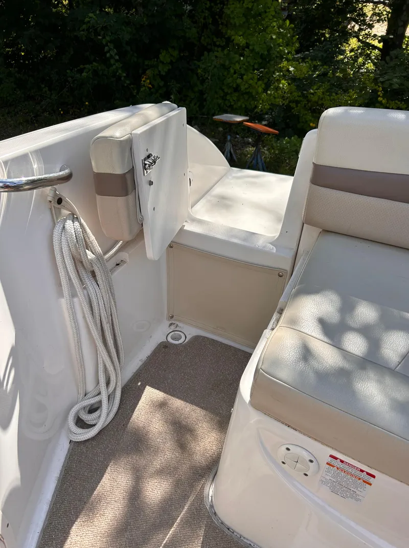 Slide: The Image of 2005 Chaparral 215 SSi boat interior with seating and storage. - 7