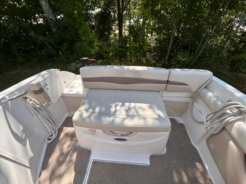 Slide: The Image of 2005 Chaparral 215 SSi boat interior with beige seating and ropes. - 8