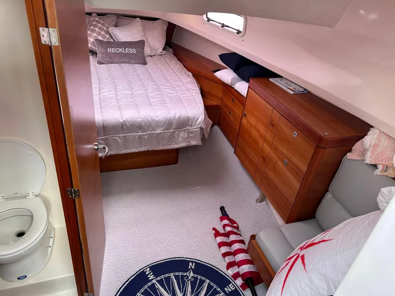 Slide: The Image of Cozy cabin interior of 2012 Fjord 40 Open yacht with bed, storage, and nautical decor. - 9