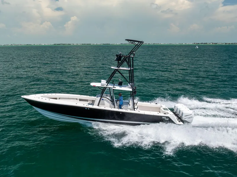 Slide: The Image of 2008 SeaVee 390 B boat cruising on open water under a cloudy sky. - 14