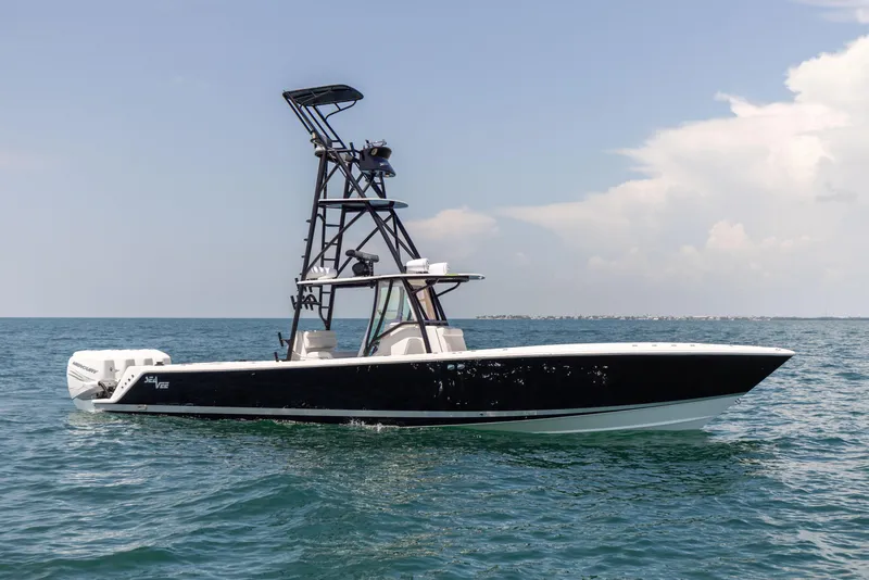 Slide: The Image of 2008 SeaVee 390 B boat on open water with clear sky. - 2