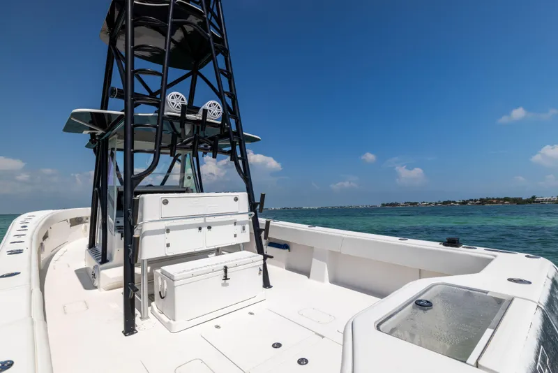 Slide: The Image of 2008 SeaVee 390 B boat on clear water, featuring a spacious deck and tower. - 22
