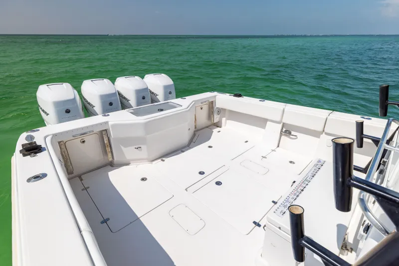 Slide: The Image of 2008 SeaVee 390 B boat with spacious deck and four outboard engines on turquoise water. - 23