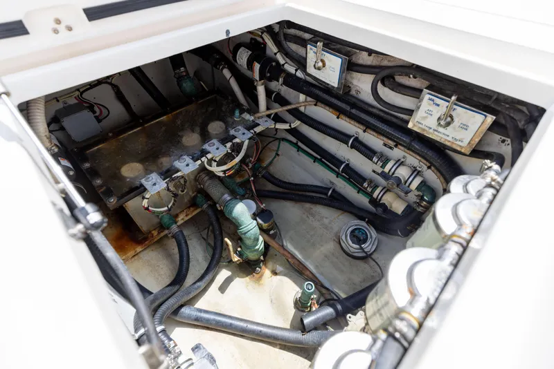 Slide: The Image of Engine compartment of 2008 SeaVee 390 B boat, showcasing intricate wiring and plumbing. - 26