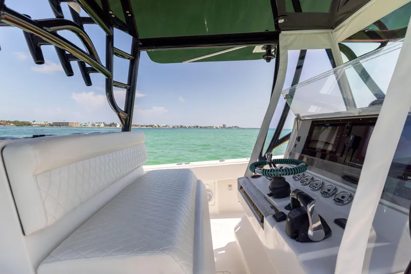 Slide: The Image of 2008 SeaVee 390 B boat interior with helm and seating, overlooking clear blue waters. - 33