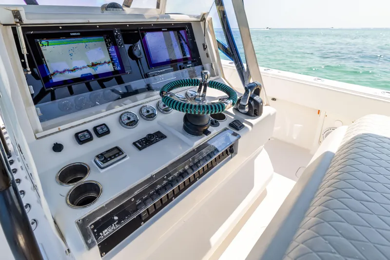 Slide: The Image of 2008 SeaVee 390 B boat dashboard with navigation screens and steering wheel. - 35