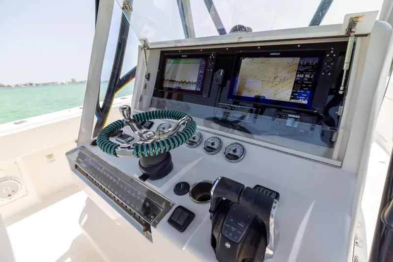 Slide: The Image of SeaVee 390 B 2008 boat dashboard with navigation screens and steering wheel. - 36