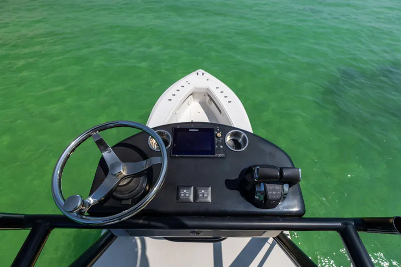 Slide: The Image of Steering console of 2008 SeaVee 390 B boat on clear green water. - 45
