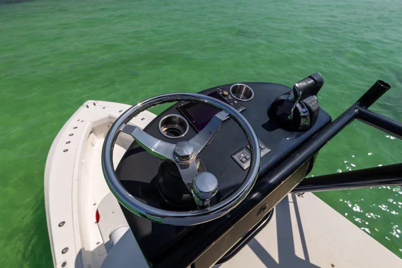 Slide: The Image of Steering console of 2008 SeaVee 390 B boat on clear green water. - 46