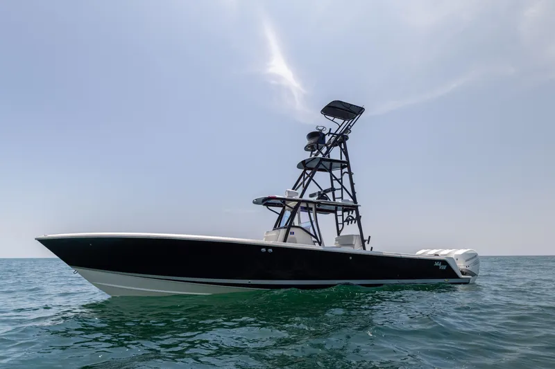 Slide: The Image of 2008 SeaVee 390 B boat on open water, featuring a sleek black hull and tower. - 6