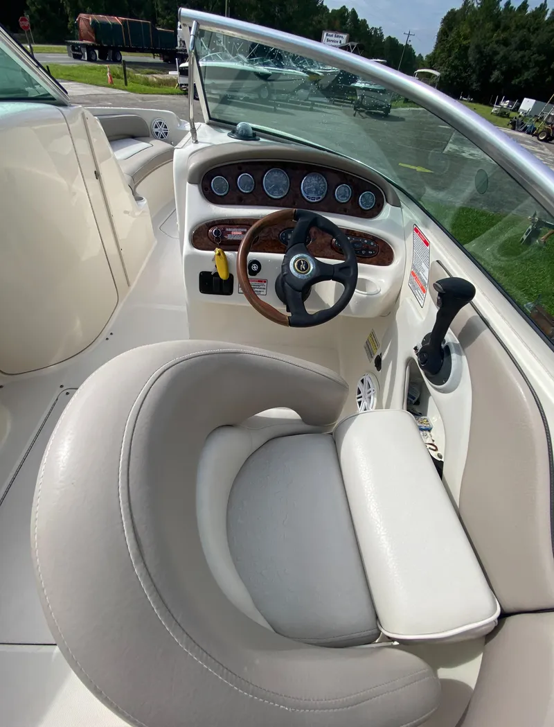 Slide: The Image of 2004 Sea Ray 240 Sundeck boat interior with steering wheel and dashboard. - 12