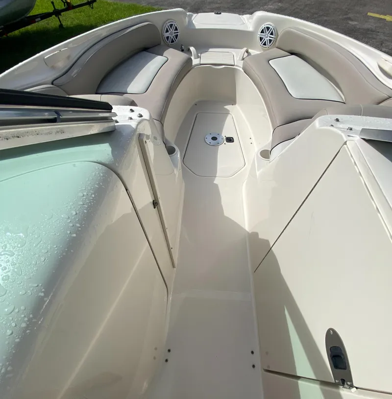 Slide: The Image of 2004 Sea Ray 240 Sundeck interior with cushioned seating and speakers. - 13