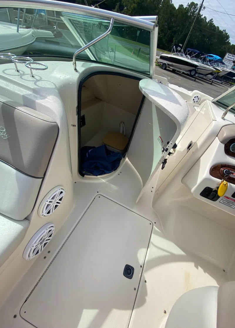 Slide: The Image of 2004 Sea Ray 240 Sundeck interior with open cabin door and seating area. - 14
