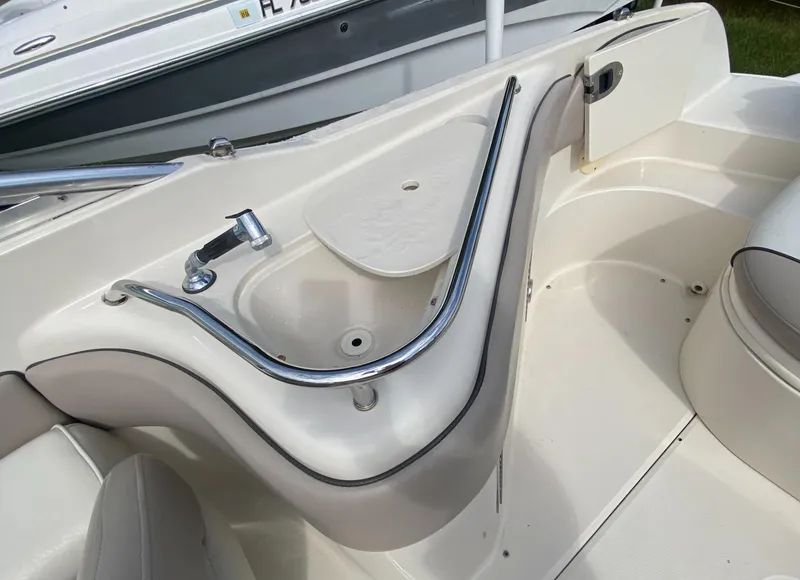 Slide: The Image of 2004 Sea Ray 240 Sundeck interior with sink and seating area. - 16