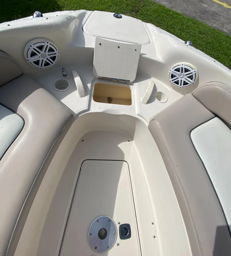 Slide: The Image of 2004 Sea Ray 240 Sundeck boat interior with seating and speakers. - 19