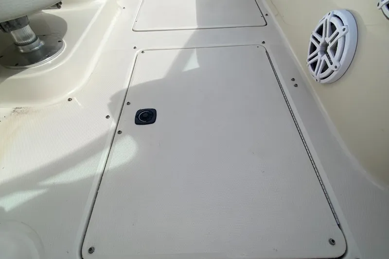 Slide: The Image of 2004 Sea Ray 240 Sundeck boat deck with storage hatch and speaker. - 24