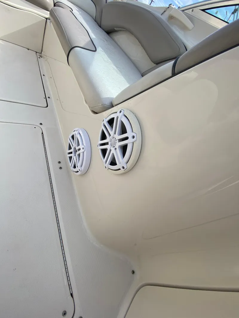 Slide: The Image of 2004 Sea Ray 240 Sundeck interior with speakers and seating. - 6