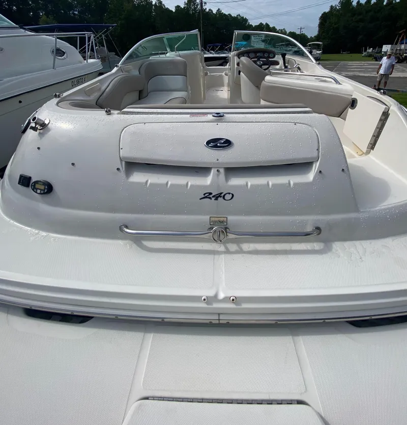 Slide: The Image of 2004 Sea Ray 240 Sundeck boat, rear view, white exterior, docked outdoors. - 8