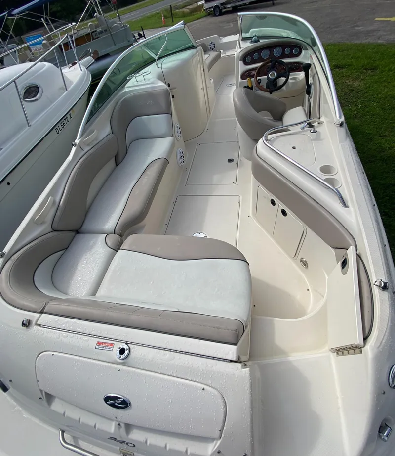 Slide: The Image of 2004 Sea Ray 240 Sundeck boat interior with spacious seating and sleek design. - 9