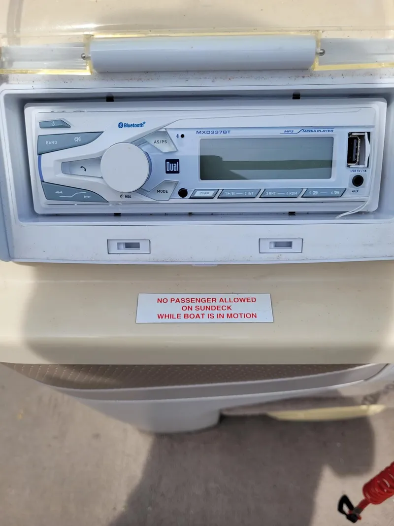 Slide: The Image of Boat stereo system on 2002 Sylvan 820 Mirage with safety warning sign. - 13