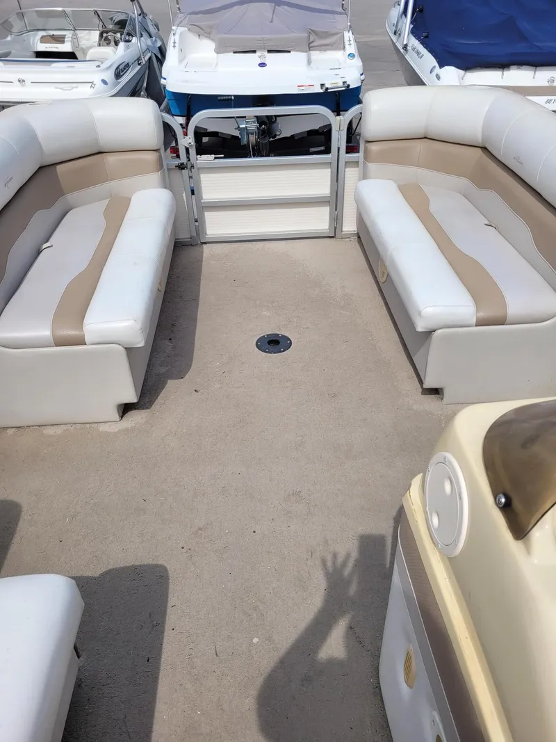 Slide: The Image of Interior of a 2002 Sylvan 820 Mirage boat with beige seating. - 14