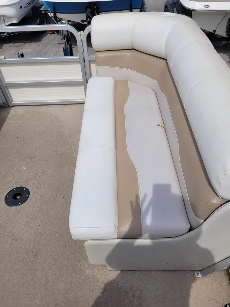 Slide: The Image of 2002 Sylvan 820 Mirage boat seating with white and beige upholstery. - 16