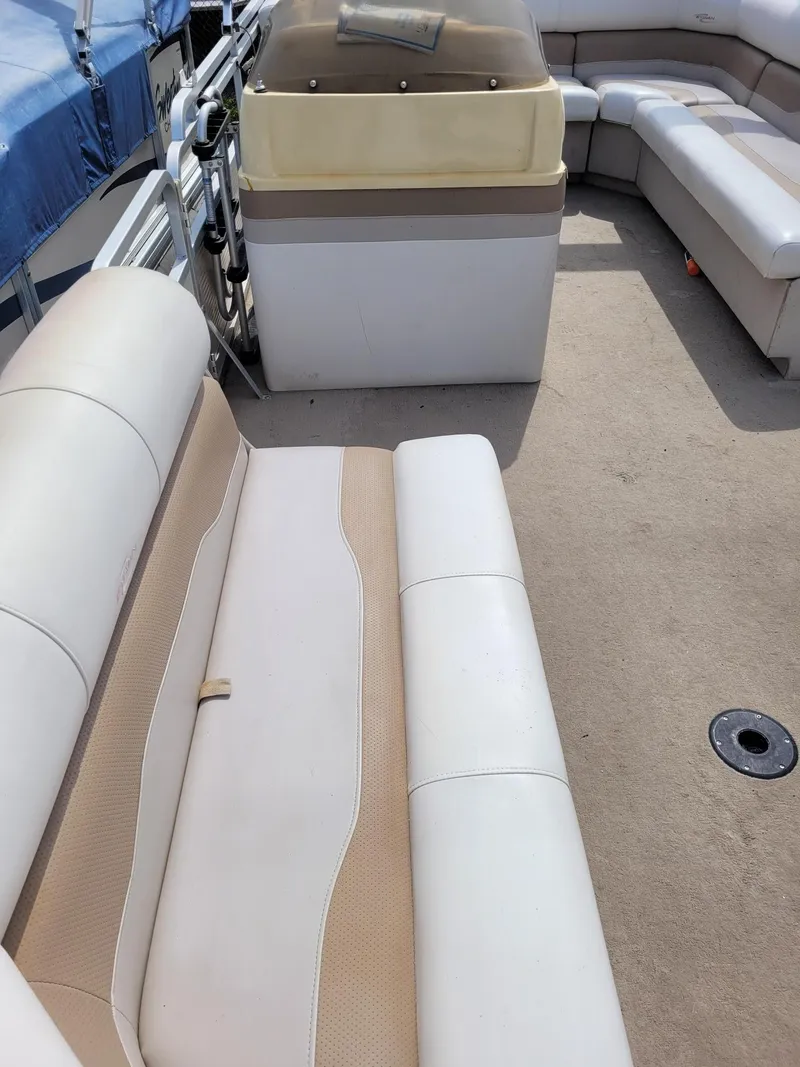 Slide: The Image of 2002 Sylvan 820 Mirage boat interior with beige and white seating. - 5