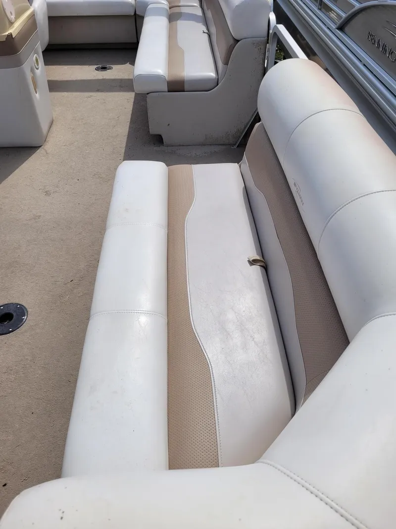 Slide: The Image of Interior seating of a 2002 Sylvan 820 Mirage pontoon boat, featuring beige and white upholstery. - 6