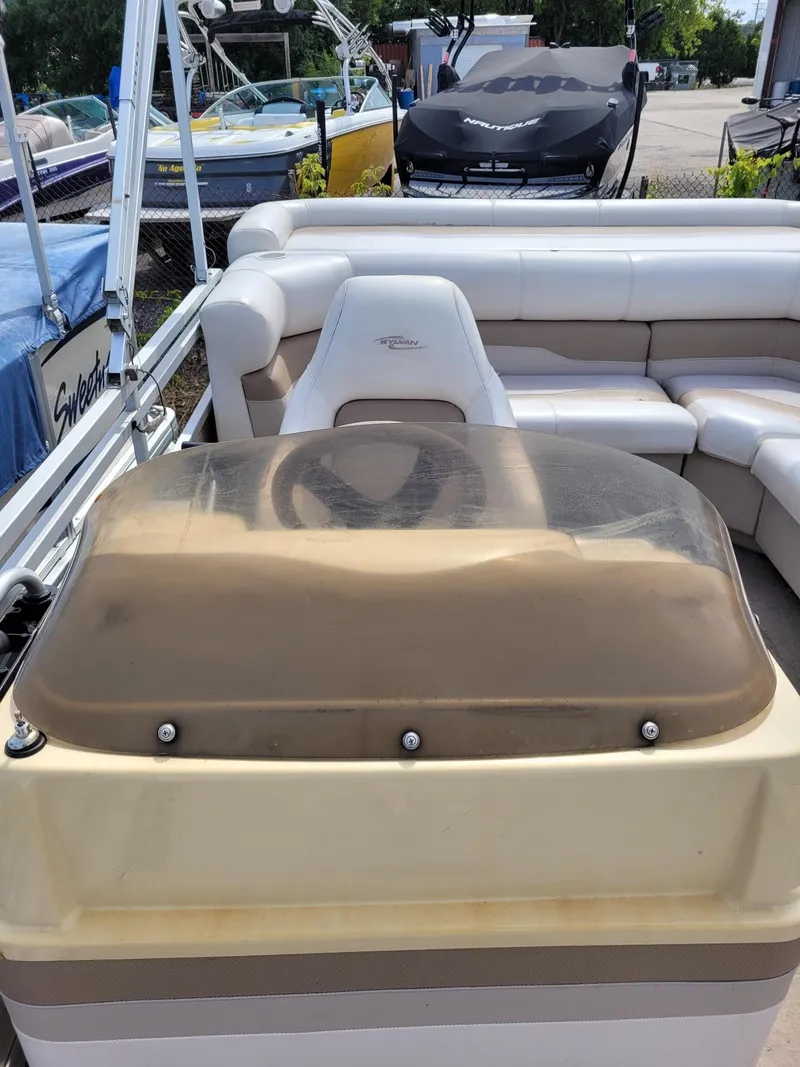 Slide: The Image of 2002 Sylvan 820 Mirage boat interior with steering console and seating area. - 7