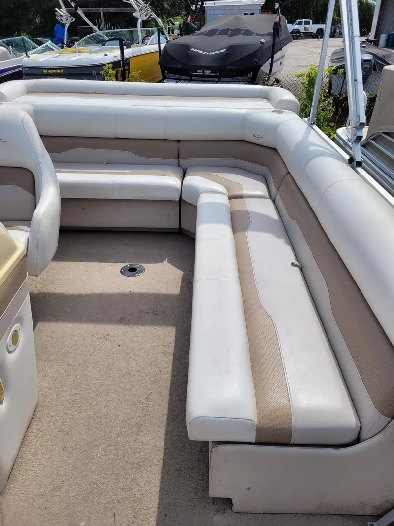 Slide: The Image of 2002 Sylvan 820 Mirage boat interior with beige and white seating. - 8