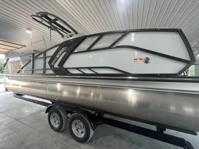 Slide: The Image of 2023 Crest Caribbean RS 250 SLC pontoon boat on trailer in garage. - 11