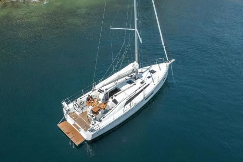 Slide: The Image of 2025 Beneteau Oceanis 37.1 sailboat on calm blue water, aerial view. - 8