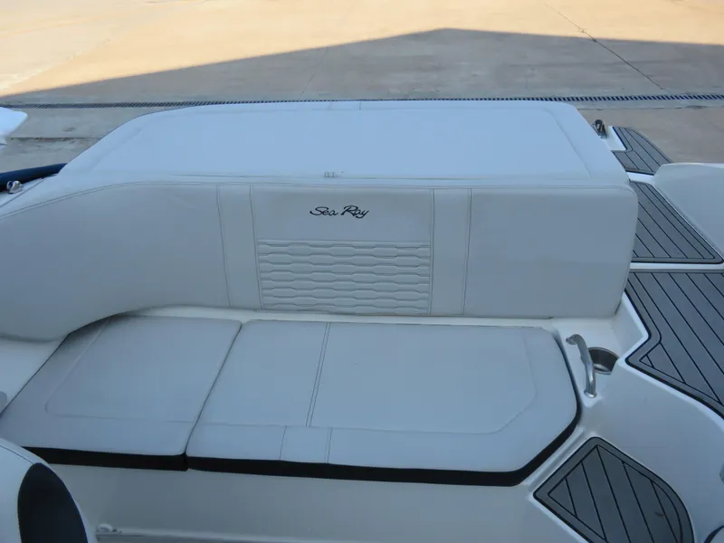 Slide: The Image of 2022 Sea Ray 19 SPX boat interior with white cushioned seating and sleek design. - 2