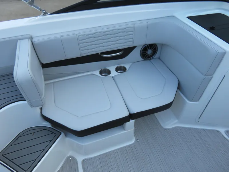 Slide: The Image of 2022 Sea Ray 19 SPX boat interior with white cushioned seating and cup holders. - 3