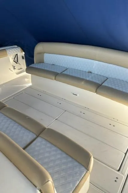 Slide: The Image of 1996 Tiara Yachts 40 Express interior seating with blue canopy and beige cushions. - 10