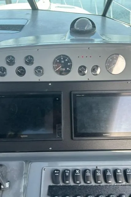 Slide: The Image of Dashboard of a 1996 Tiara Yachts 40 Express with gauges and controls. - 12