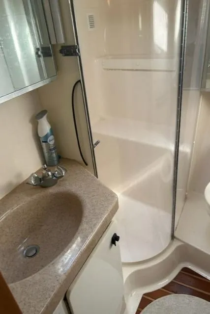 Slide: The Image of 1996 Tiara Yachts 40 Express bathroom with sink, mirror, and shower. - 15