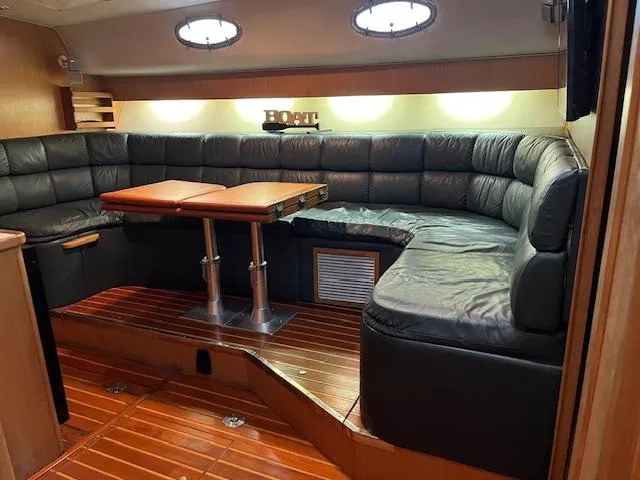 Slide: The Image of Luxurious interior of 1996 Tiara Yachts 40 Express with leather seating and wooden flooring. - 16