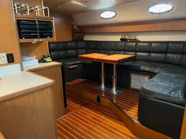 Slide: The Image of 1996 Tiara Yachts 40 Express interior with leather seating and wooden flooring. - 19