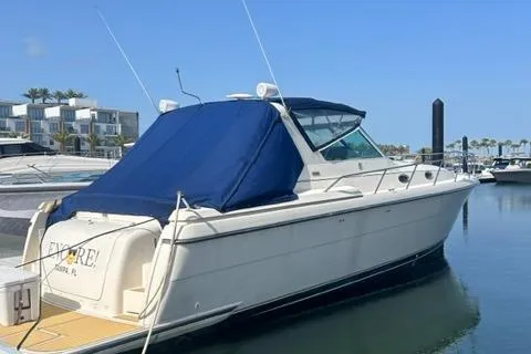 Slide: The Image of 1996 Tiara Yachts 40 Express docked, featuring a blue canopy and sleek design. - 2