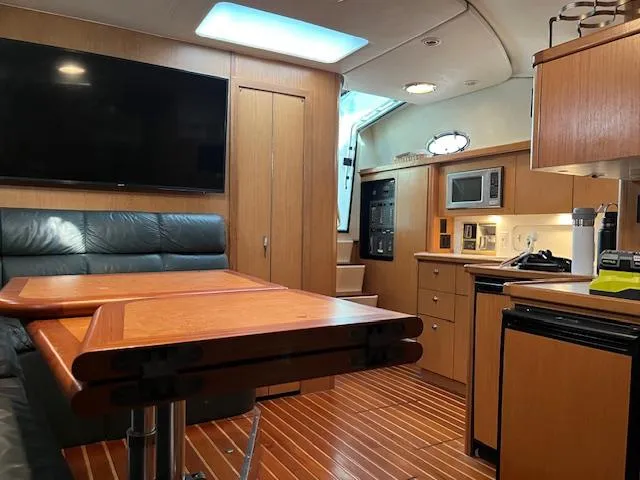 Slide: The Image of Interior of 1996 Tiara Yachts 40 Express with wood finish, seating, and kitchenette. - 22