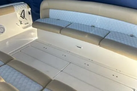 Slide: The Image of 1996 Tiara Yachts 40 Express interior seating with beige and white upholstery. - 8