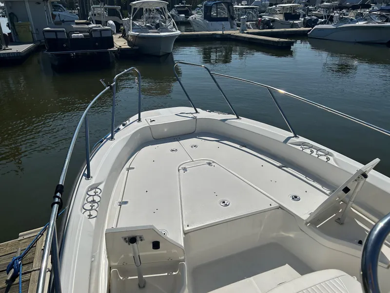 Slide: The Image of 2013 Boston Whaler 230 Dauntless boat docked in marina, sunny day. - 10