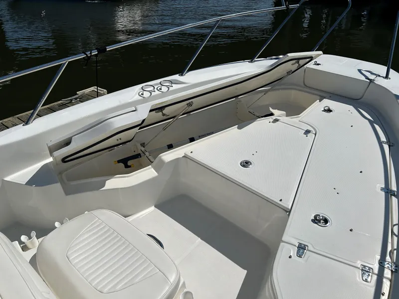 Slide: The Image of 2013 Boston Whaler 230 Dauntless boat interior, featuring white seating and deck. - 11