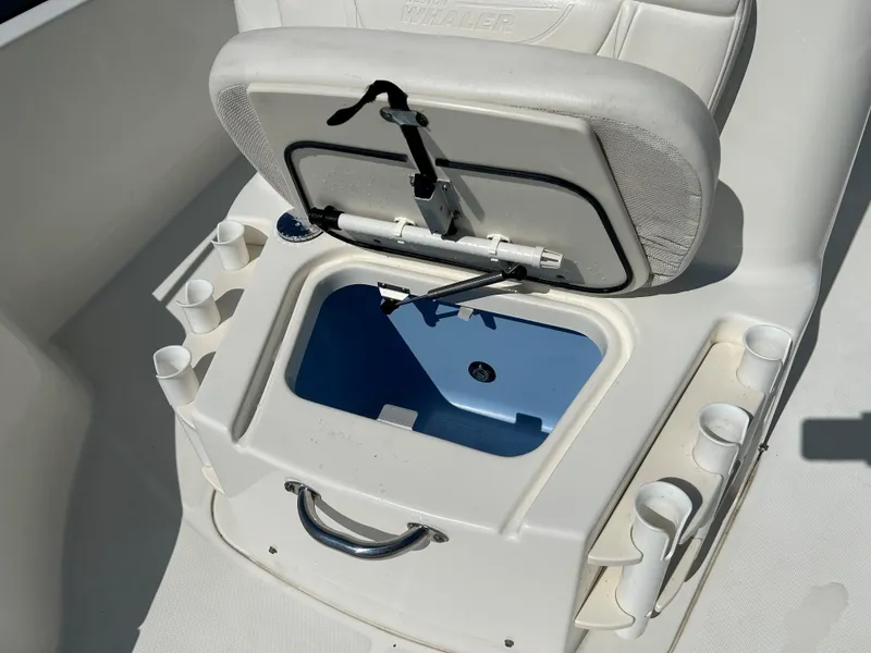 Slide: The Image of Boston Whaler 230 Dauntless 2013 boat seat with storage compartment and cup holders. - 13