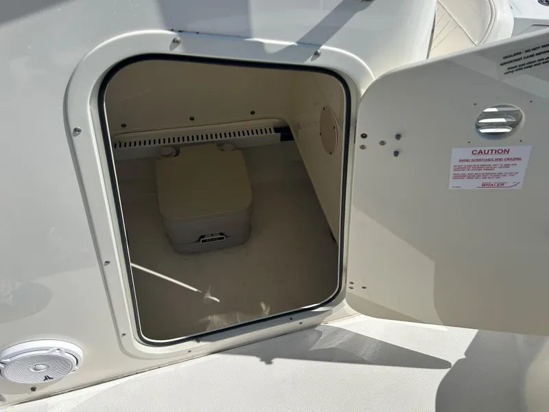 Slide: The Image of Open storage compartment on 2013 Boston Whaler 230 Dauntless boat. - 14
