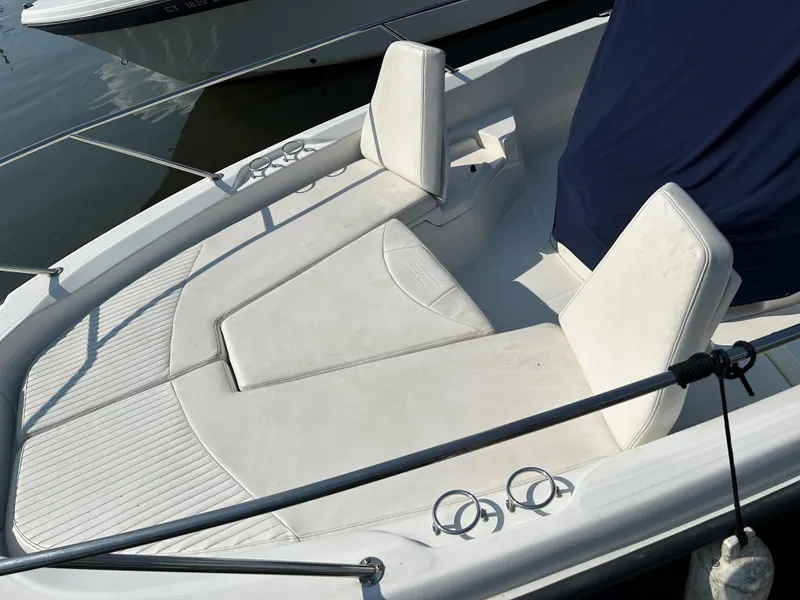 Slide: The Image of 2013 Boston Whaler 230 Dauntless boat with white seating and covered console. - 18