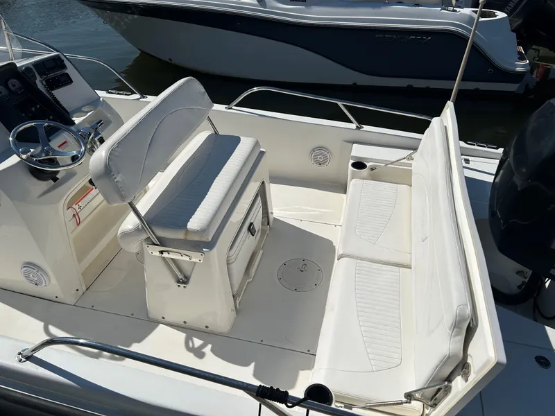 Slide: The Image of 2013 Boston Whaler 230 Dauntless boat interior with seating and steering console. - 6