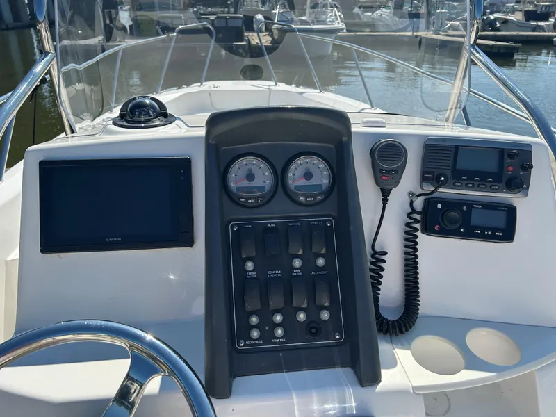 Slide: The Image of 2013 Boston Whaler 230 Dauntless boat dashboard with gauges and controls. - 8
