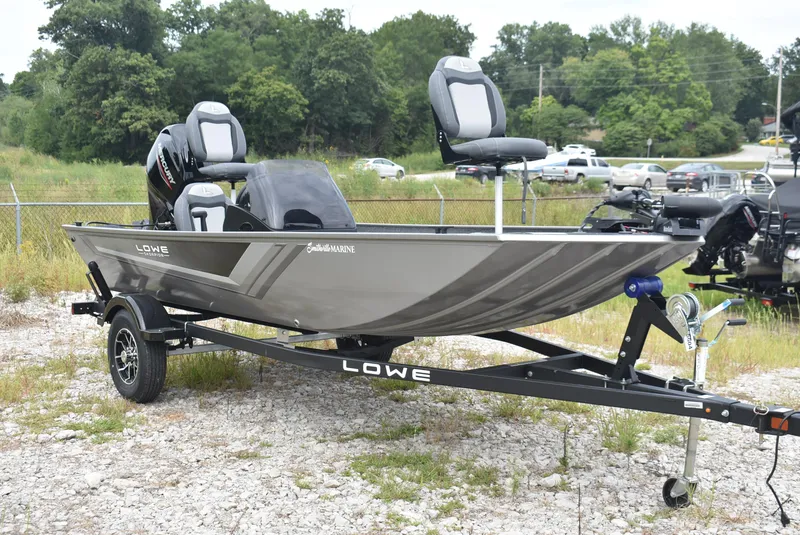 Slide: The Image of 2025 Lowe 16 Skorpion fishing boat on trailer, parked outdoors. - 3
